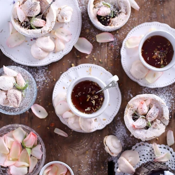 Just a cup of tea presented in some sort of pleasing way. Although, tea with edible flowers plus meringue cookies with rose petals ganache make a great combination of flavours! <br />
The idea was simply to create a lovely atmosphere.