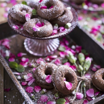 Chocolate donuts with edible flowers - something that everyone has to try out, their taste can simply blow out one's mind.
