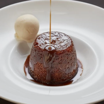 Sticky Toffee Pudding is a British treasured dish. Full of brown sugar, dates & caramel flavours, it's truly delicious. <br />
<br />
This is from a recent shoot at private members club Homehouse, Portman Square, London. <br />
Recently appointed head chef, Fabio Petrucci, created this stunning dish with homemade vanilla ice cream. <br />
<br />
Restaurant: @homehouselondon<br />
Chef: Fabio Petrucci