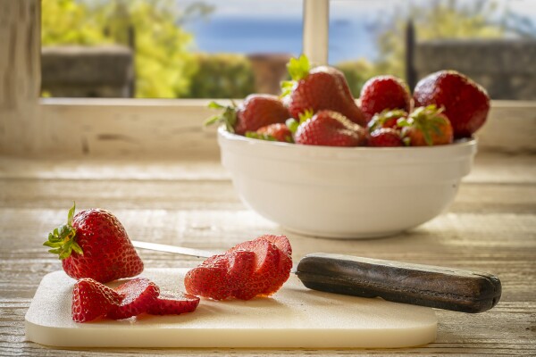 Cruising through the grocery store, the beauty of the fresh strawberries caught my eye.  I had just made a new white wood surface for my food shots and immediately though of creating a fresh morning look of strawberries being cut by the kitchen window.  I made both the surface and the window frame and layered in a view I had captured on a recent trip to Italy.