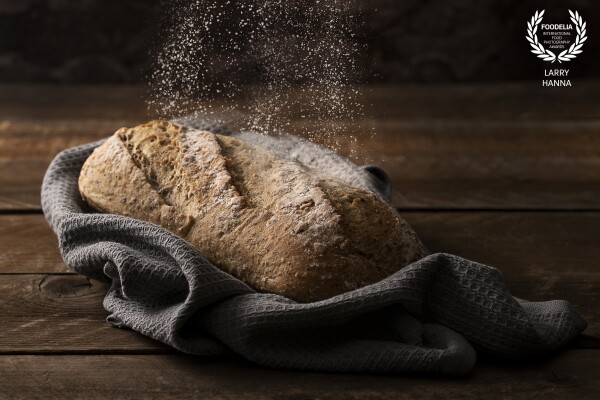 I love the beauty of artisan bread loaves.  I photographed this loaf right out of the oven getting a little dusting.  This was created for my own use.<br />
<br />
