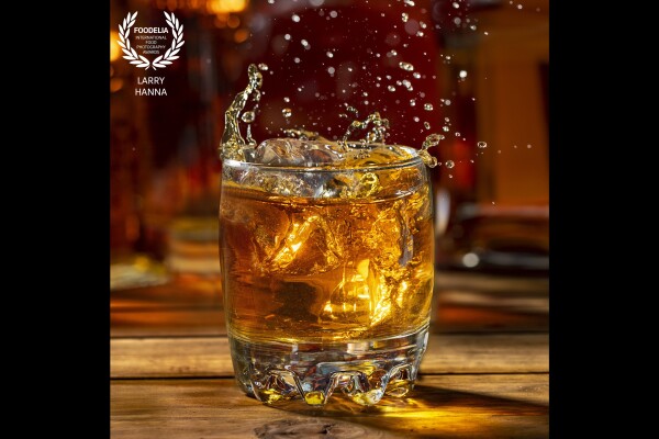 When I have free time, I like to create images of things I love.  I love bourbon.  I arranged several bottles of bourbon as a background and then dropped acrylic ice cubes in to the glass of bourbon.  I did have one casualty when an errant ice cube hit the side of the glass breaking it.