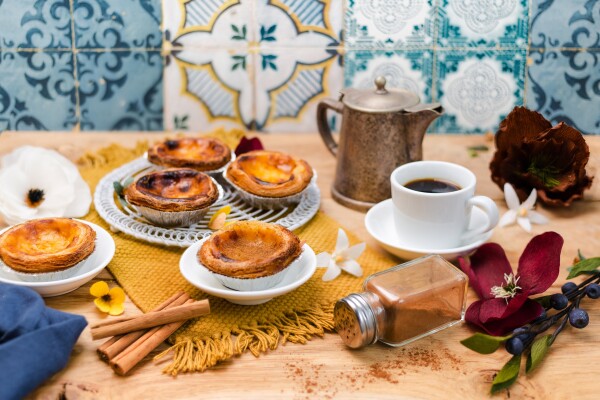 Pastéis de Nata
Feeling inspired by Portuguese vibes and these delicious tartlets recommended by my favorite Portuguese shop in Leidschendam @marqasa.nl; handmade paper flowers made by the incredible artist @anoukbohmer definitely compliment the mood and brings me back to any cozy coffee place in Lisbon.
Camera: Canon 5D Mark III
Lens: 50 mm 
Settings: ƒ/2.8 1/125 ISO100 daylight