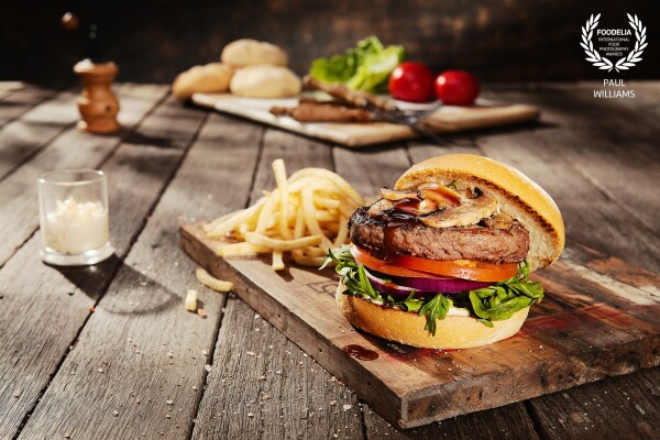 This award-winning Australian Wagyu beef burger was actually shot in-studio.<br />
The light was created to replicate outdoor sunlight shining through a gumtree canopy.<br />
This effect was achieved by custom-making an intricate flag to fire my 500-watt key light through.<br />
The result is a uniquely Australian quality of light - and one very happy client!