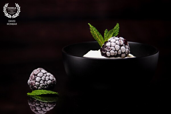 Frosted blackberries served over mint yogurt and decorated with mint leaves.
