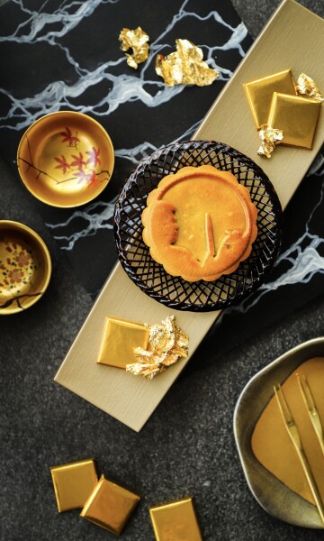 Matcha Lotus, Black Sesame and Valrhona Chocolate Mooncake. A special mooncake for Mid-Autumn Festival celebration this year, created by Chef Hideki Maeda of Nobu Singapore at Four Seasons Hotel Singapore. As this particular delicacy is incorporating Japanese culture into a traditional Chinese, the props used are a reflection of both cultures. The golden color chosen for this scene was inspired by the luxurious lacquered gift box that came with the mooncakes.