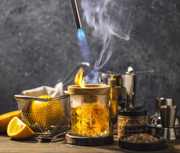 Smoked Old Fashioned. Adding smoke to this classic cocktail adds depth of flavor that complements the bourbon, while the simple syrup is infused with rosemary, which also plays a role as a swizzle stick