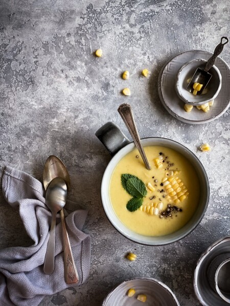 Corn soup served with a fresh mint.