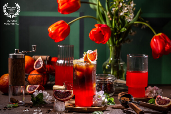 Mood of spring tulip flowers. Coffee with fresh Sicilian Blood orange juice.