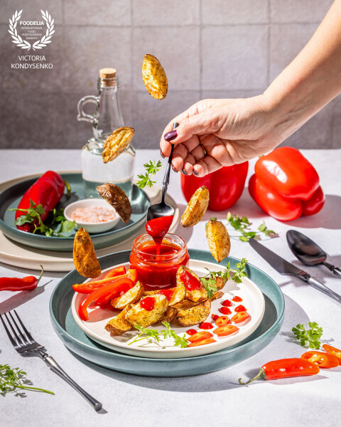 Roasted potato wedges with marmalade pepper sauce. Advertising photo shoot of the local Ukrainian garden family farming.