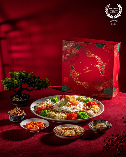 This photograph highlights the vibrant colors and intricate presentation of Yee Sang, the iconic Chinese New Year dish symbolizing abundance and prosperity. Captured for Sunway Resort Kuala Lumpur, the image showcases the harmonious blend of fresh ingredients in an elegant, festive setting.<br />
<br />
The lighting and balanced composition celebrate the cultural tradition of the prosperity toss, evoking joy and togetherness as families and friends gather to usher in good fortune.