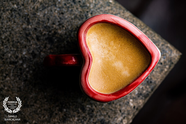 The heat of the heart-shaped mug warms your hands and heart.  The dark, steaming drink offers a satisfying sensory experience.  A small gesture of self-love, enclosed in a special cup.<br />
https://www.instagram.com/foodphotographyroma?igsh=ZjN0OXUyMHhxcXdi