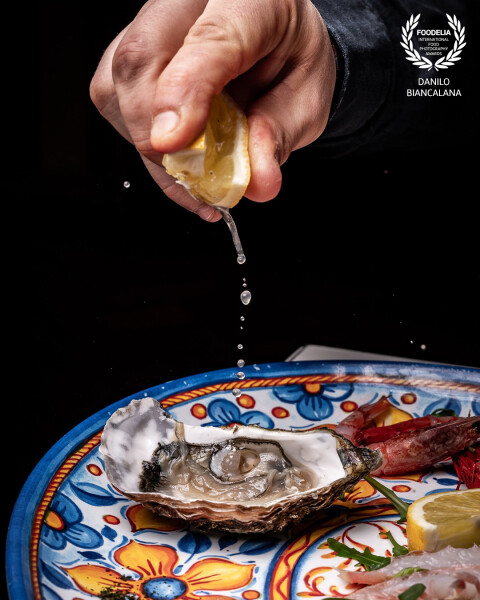 The combination of a fresh oyster with a squeeze of lemon is a real delight for the palate.  The delicate flavor of the mollusk pairs perfectly with the citrus acidity.<br />
https://www.instagram.com/foodphotographyroma?igsh=ZjN0OXUyMHhxcXdi
