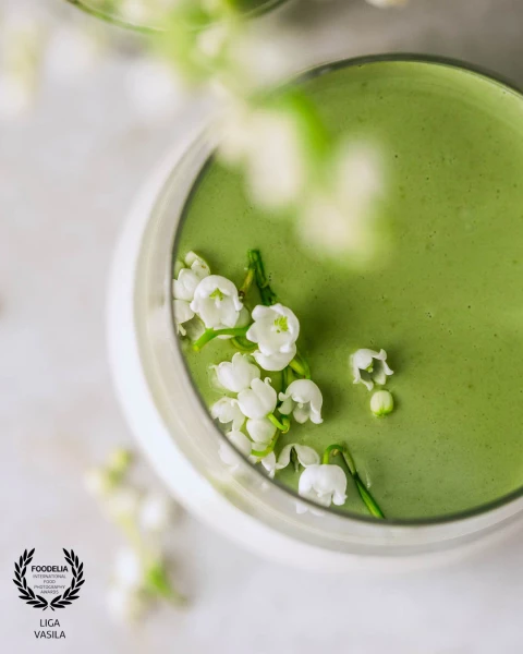 This image highlights the vibrant green matcha on the creamy white panna cotta, with May birth flowe...