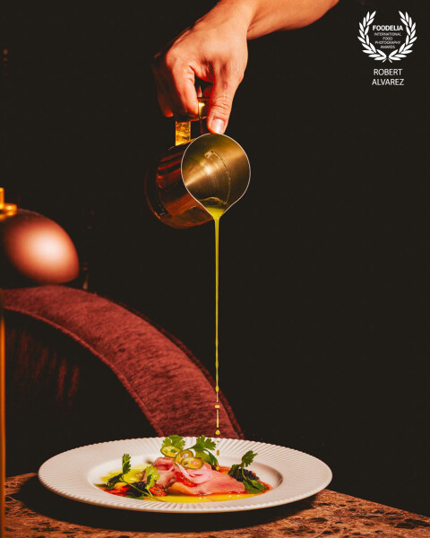 This photo, taken at DRGN Restaurant in San Juan, captures the artistry of plating in motion—a strea...