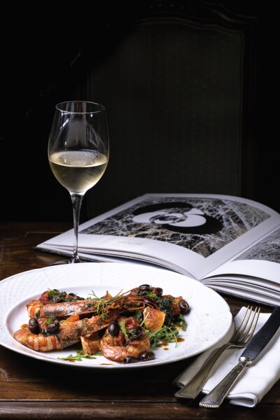Savor the taste of relaxation: prawns, white wine, and a good book . 
Photoshoot for advertising