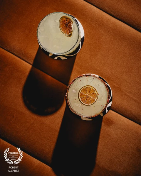 Two margaritas shot from directly above — but the cocktails are almost secondary to what the light i...