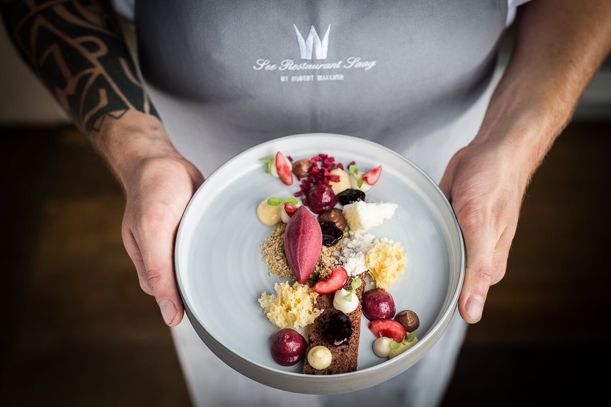 This dish is a modern interpretation of „Black Forest cake“. All components of the cake were brought to the dish separately. The idea was to show the dish in the hands of the chef to capture a new and interesting perspective.