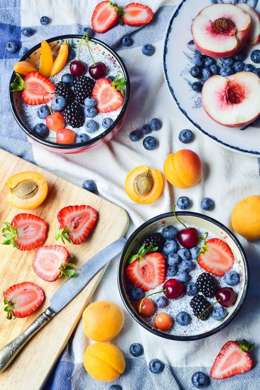 This photo was taken in a beautiful summer day. Bright breakfast of chia seed pudding with fresh seasonal fruit and berries. I want to convey a bit of summer mood to anyone who sees this picture.