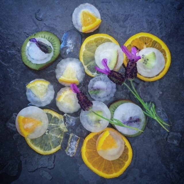 This shot is a simple study of fruits and lavender in ice, showcasing the vibrant and refreshing colours of late Spring/early Summer.  Tiny segments of orange, lemon, kiwi fruit and and lavender heads were frozen in normal tap water to give the opaque finish. 