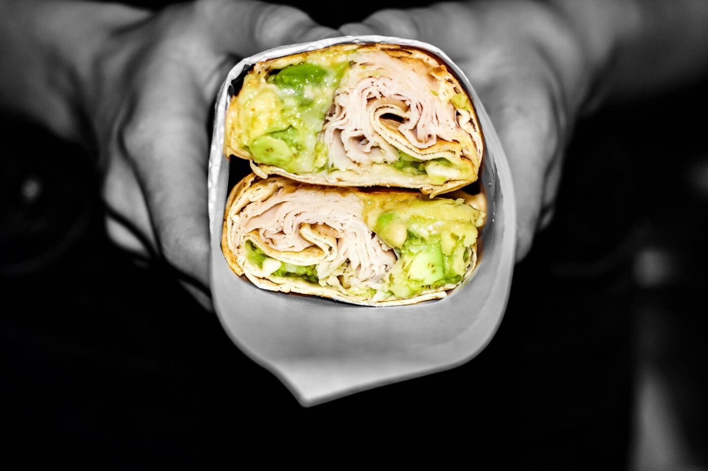 One of the most important elements of enjoying food is knowing that it looks so tasty. This turkey and avocado wrap represents the simple combination of ingredients that are required to make a delicious snack, and the black and white contrasting effect on the image only emphasises the bright colour of this summery food. Its great to remember that a healthier option can look and taste yummy too!<br />
This photograph was taken at our favourite St Andrews lunch venue Blackhorn, who specialise in creating beautiful handmade burgers, wraps and salads using only fresh and local produce.