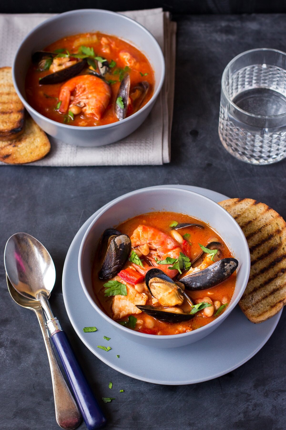 This is a photo of a simple fish and seafood soup made according to an italian recipe with cannellini beans and tomatoes. I made it for my husband who is a huge fan of all seafood dishes.