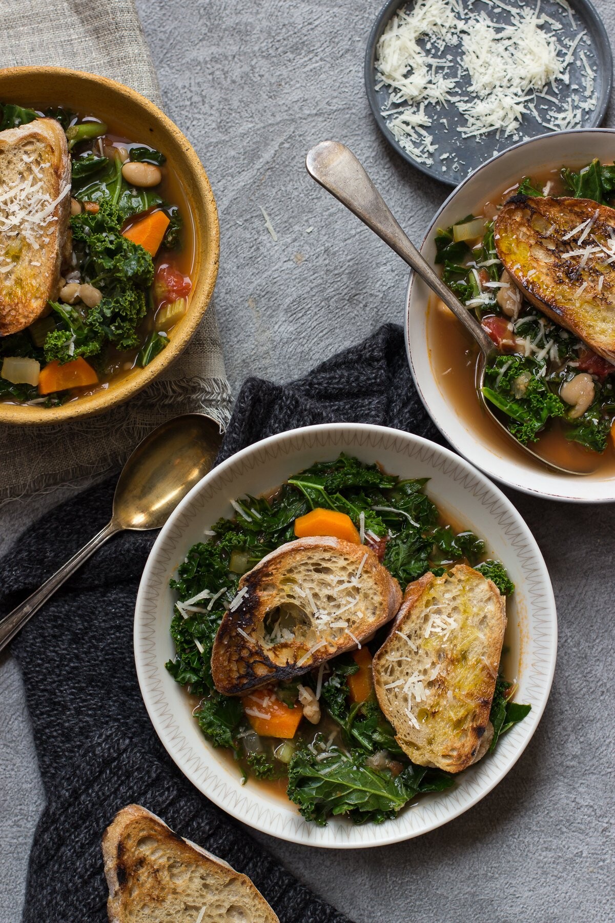 This is my quick and easy twist on famous Toscan soup - ribollita. I made it with cannelini beans, tomatoes and kale and served with parmesan garlic toasted bread.  The idea behind this picture was to make it look rustic and autumnal. 