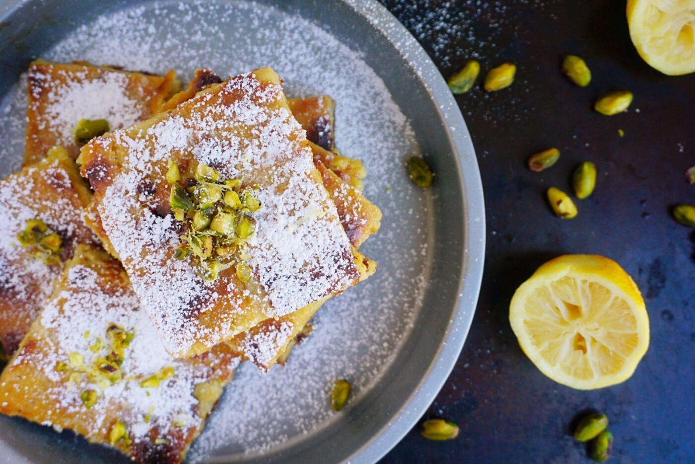 "Galatopita"  a traditional Greek dessert. This milk custard pie is silky,citrusy  with the beautiful addition of pistachios. A gluten free twist on a family recipe.
