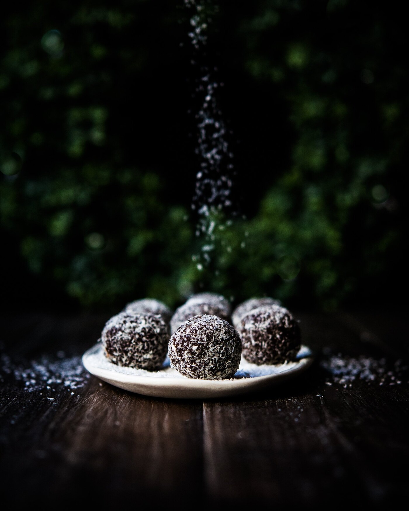 I wanted to capture the motion of falling snow by sprinkling fine coconut shreds onto this plateful of chocolaty ginger garam masala balls infused with rum.   It is wonderful to introduce this holiday spirit on my table.