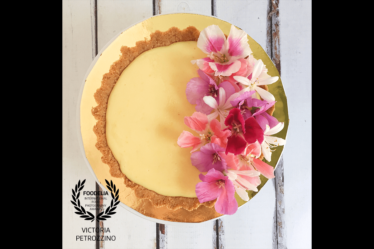 This is a lemon pie decorated specifically for a wedding. When I took this picture I was trying to capture the contrast of yellow and violet between the lemon curd and the flowers.