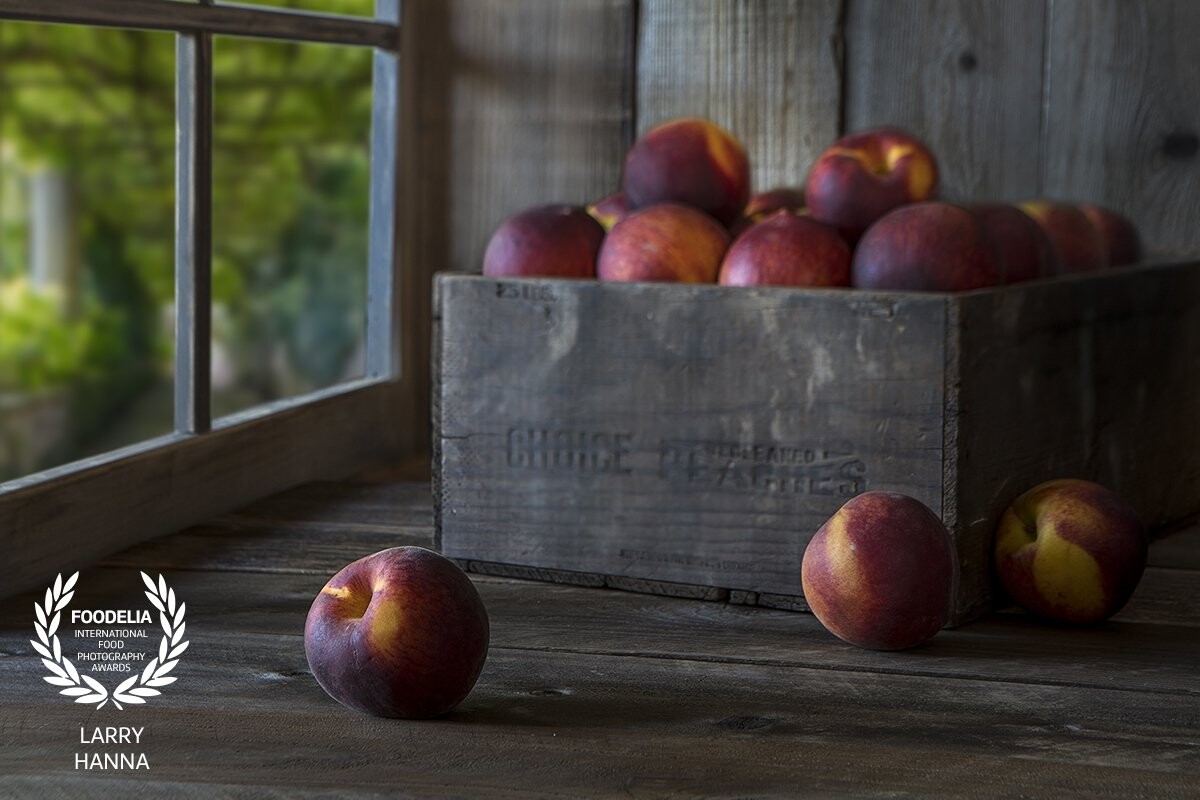 Whenever I have some down time, I like to create a still life image.  I bought this old peach crate on eBay to have for use as a background element, with no immediate use in mind.  I photographed this shot in my kitchen dining area using only window light.  I made the window frame and propped up some old barn wood for the background and foreground.  The window scene was photographed on a recent trip to Ravello, Italy.