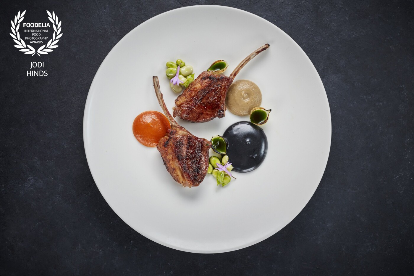 Wood smoked lamb cutlets with charcoal mayonnaise, burnt aubergine, tomato & red pepper ketchup from the talented @mikereidchef at @mrestaurants_<br />
Beautifully simple with incredible flavours!<br />
Thank you so much for the award!<br />
@jodihindsphoto