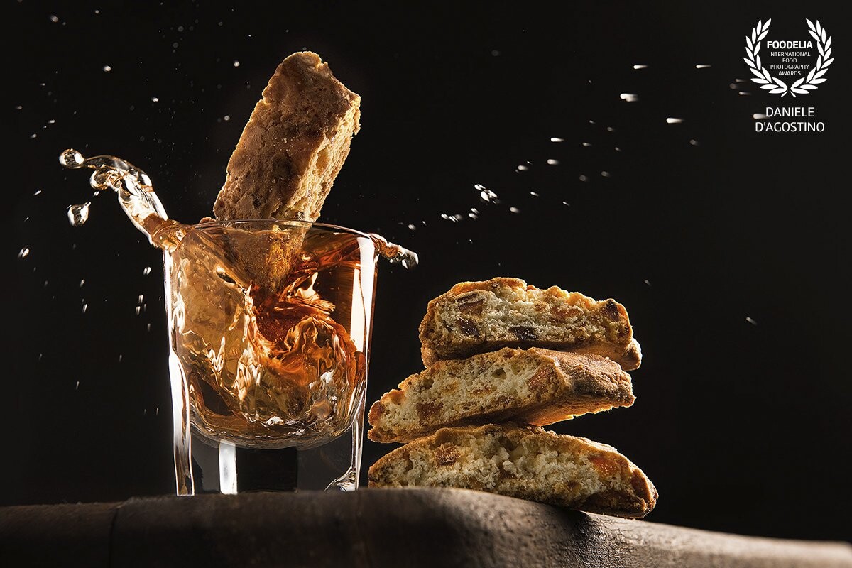 "Cantucci and Vin Santo"<br />
Vin Santo is a fine Tuscan wine that is usually tasted along with cookies called "cantucci" . Cookies, as you can see in the photo, are dipped in wine to bring out the flavors. <br />
Work commissioned by Dante’s, a Touscan Restaurant Chain. <br />
Photographer and stylist :Daniele D’Agostino
