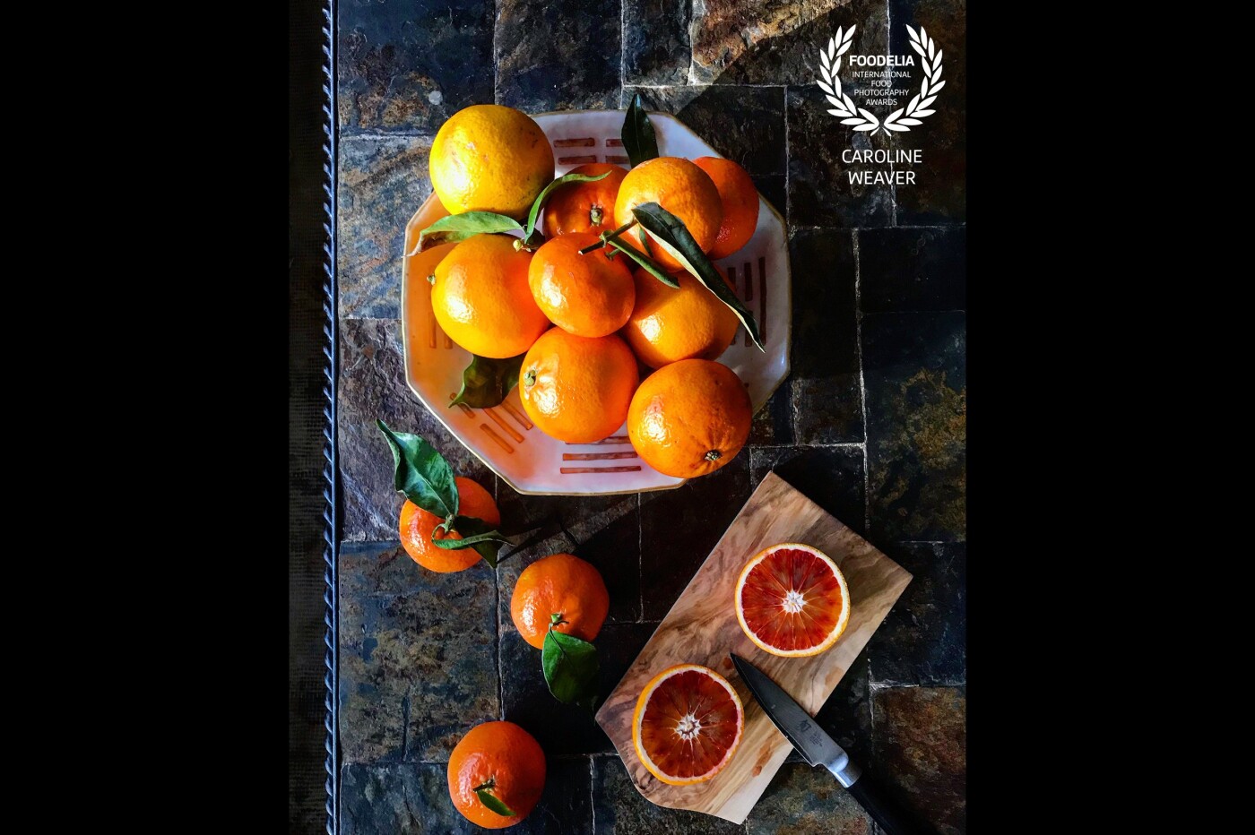 Using the last rays of the winter sun to recreate a Dutch still life. Juicy blood oranges and clementines in an ancient Chinese Ming dish reflecting back on a Welsh slate coffee table.