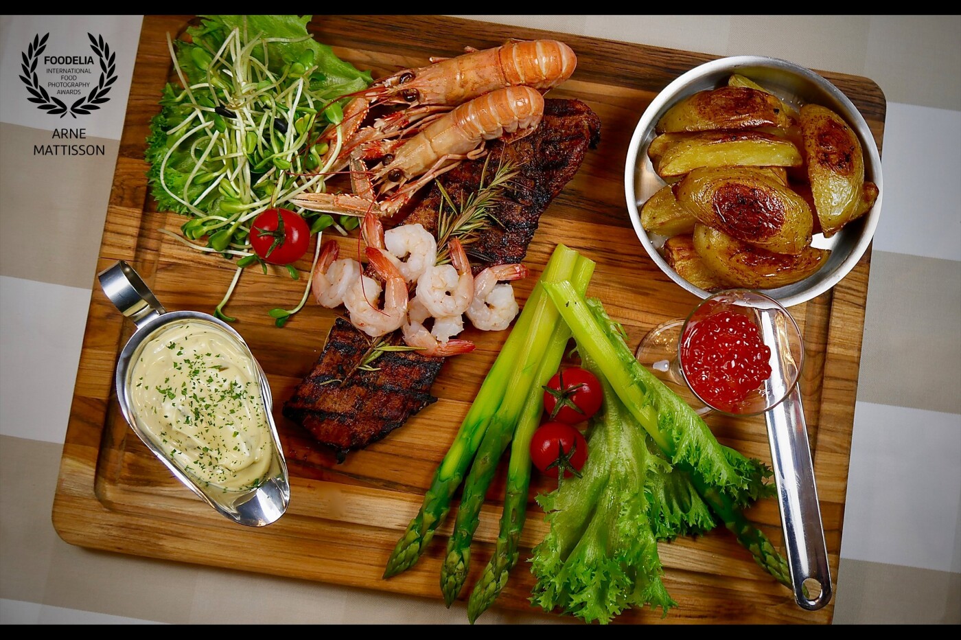 Surf and turf board including grilled pork tender loin with Bearnaise sauce, potato wedges, asparagus, shrimps and crawfish and of course one shot of salmon roe. My motivation is passion. I prepare all of the dishes by myself and after that it's a challenge to take the pic because I normally have a few minutes to take the pic before I have to eat it.<br />
Instagram: @arnesmat<br />
Homepage: www.arnesmat.se