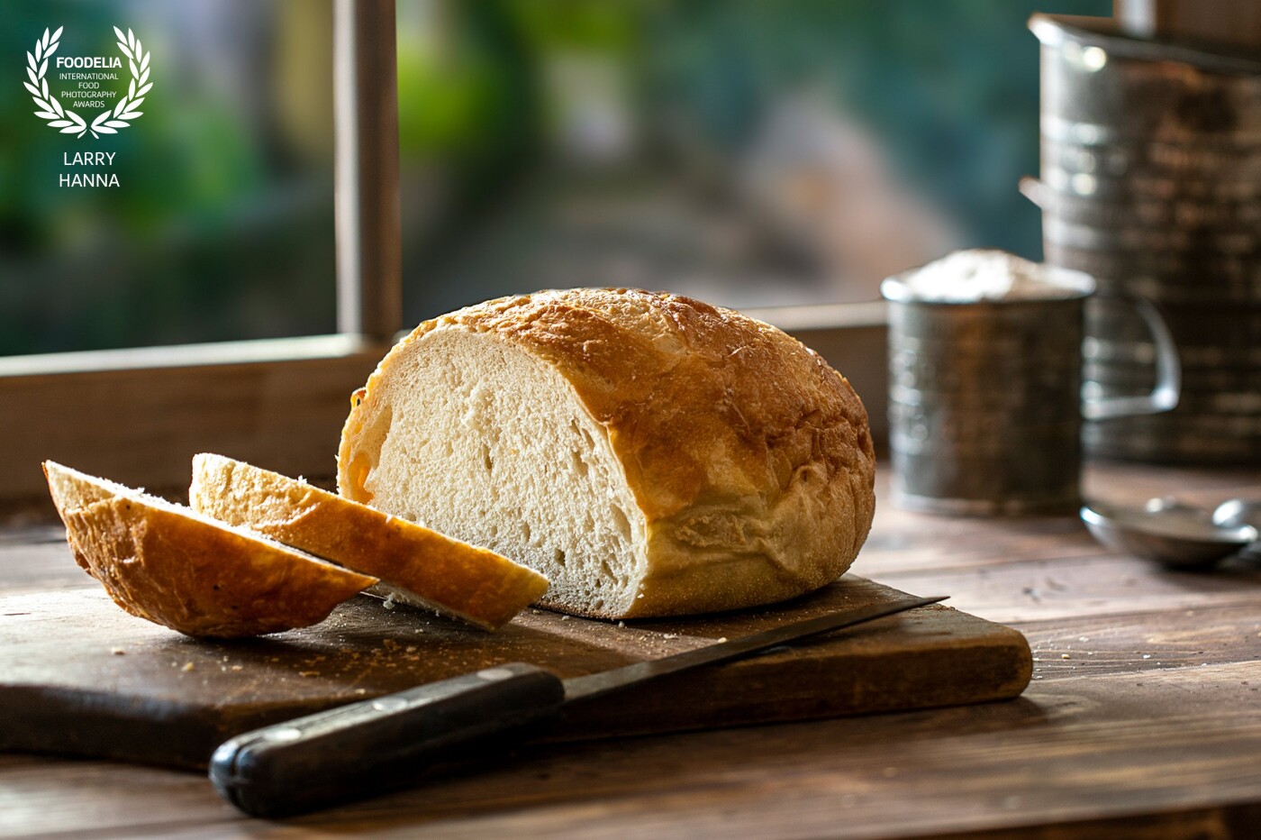 One of my favorite things to photograph and eat is bread.  I created this set in my kitchen using only window light.  The out of focus view in the window is an image I created in Ravello Italy last year.