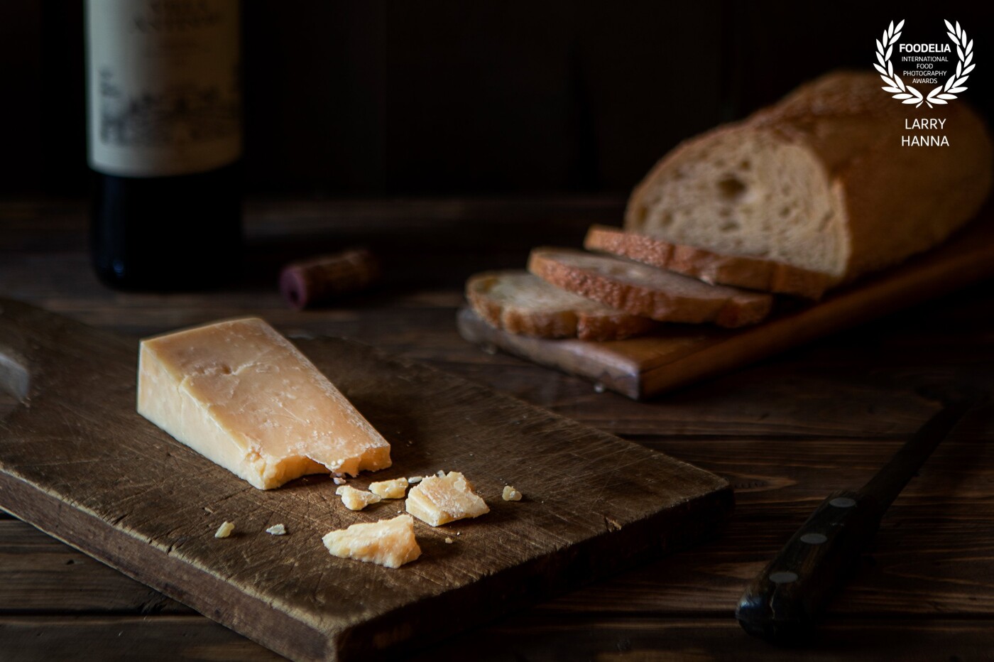 In the evening, I love to break off bites of a good parmesan cheese and combine with a good red wine and bread.  I created this shot for my own enjoyment.  I created the little set in my breakfast area using only window light to tell the story.