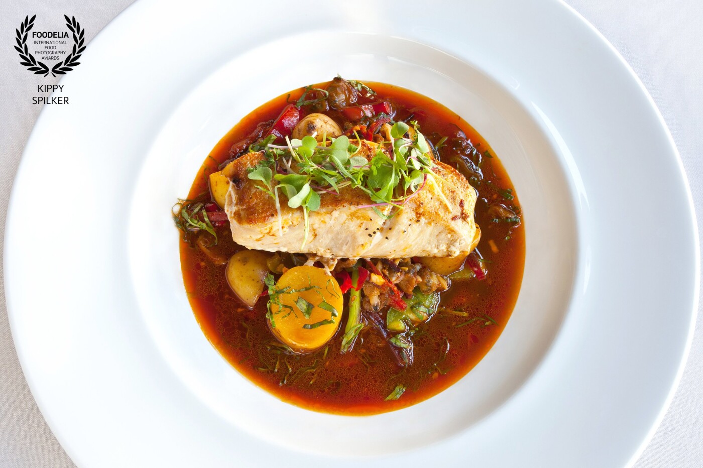Seared California white bass, fingerling potatoes, Spanish chorizo, baby clams, peppers and Portuguese pork broth. <br />
Prepared and presented at 1862 David Walley's Hot Springs in Genoa, Nevada.