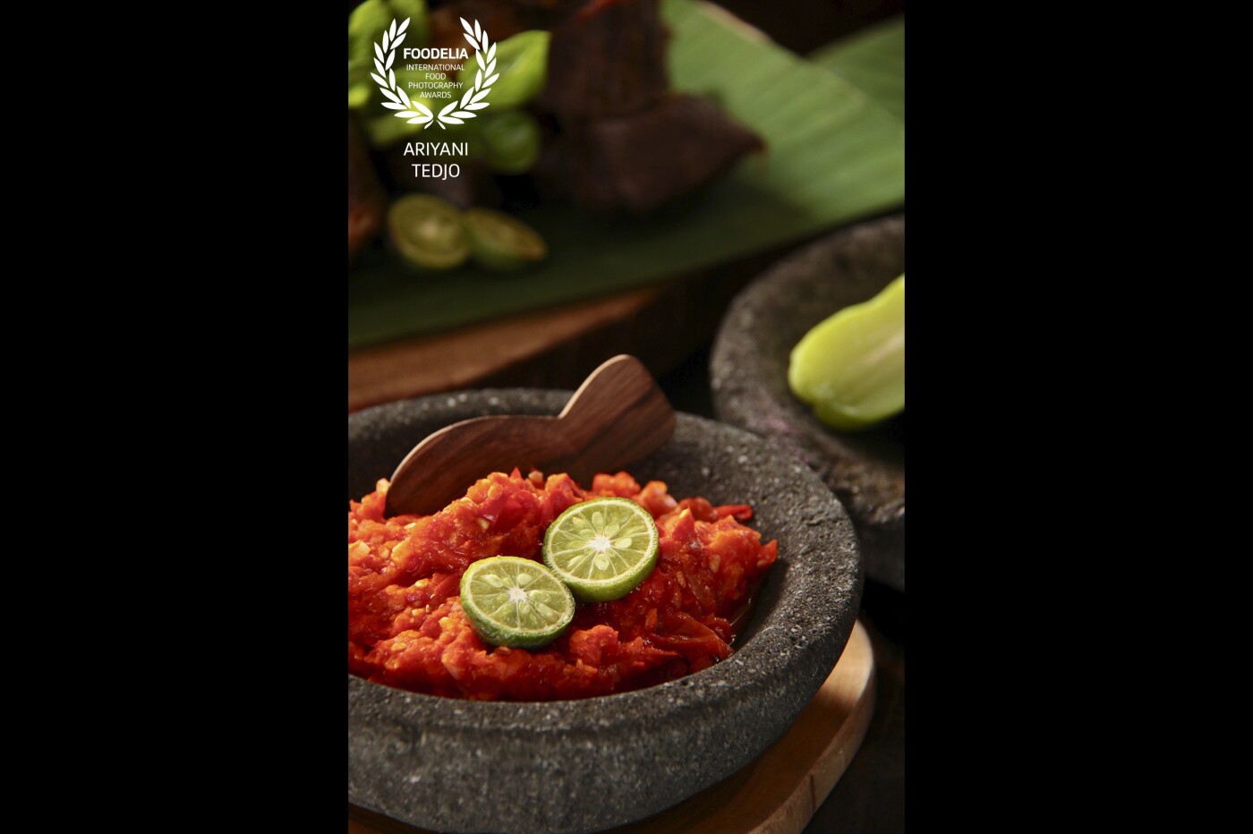 Sambal Oelek, the most popular Indonesian spicy condiment that goes well with many local dishes. Red chili peppers crushed into rough paste in a traditional stoneware mortar and pestle, with some tomatoes and fermented shrimp paste added. Just before serving, a dash of fragrant limau kasturi lime juice is added to the paste for some fresh tart and aroma. 