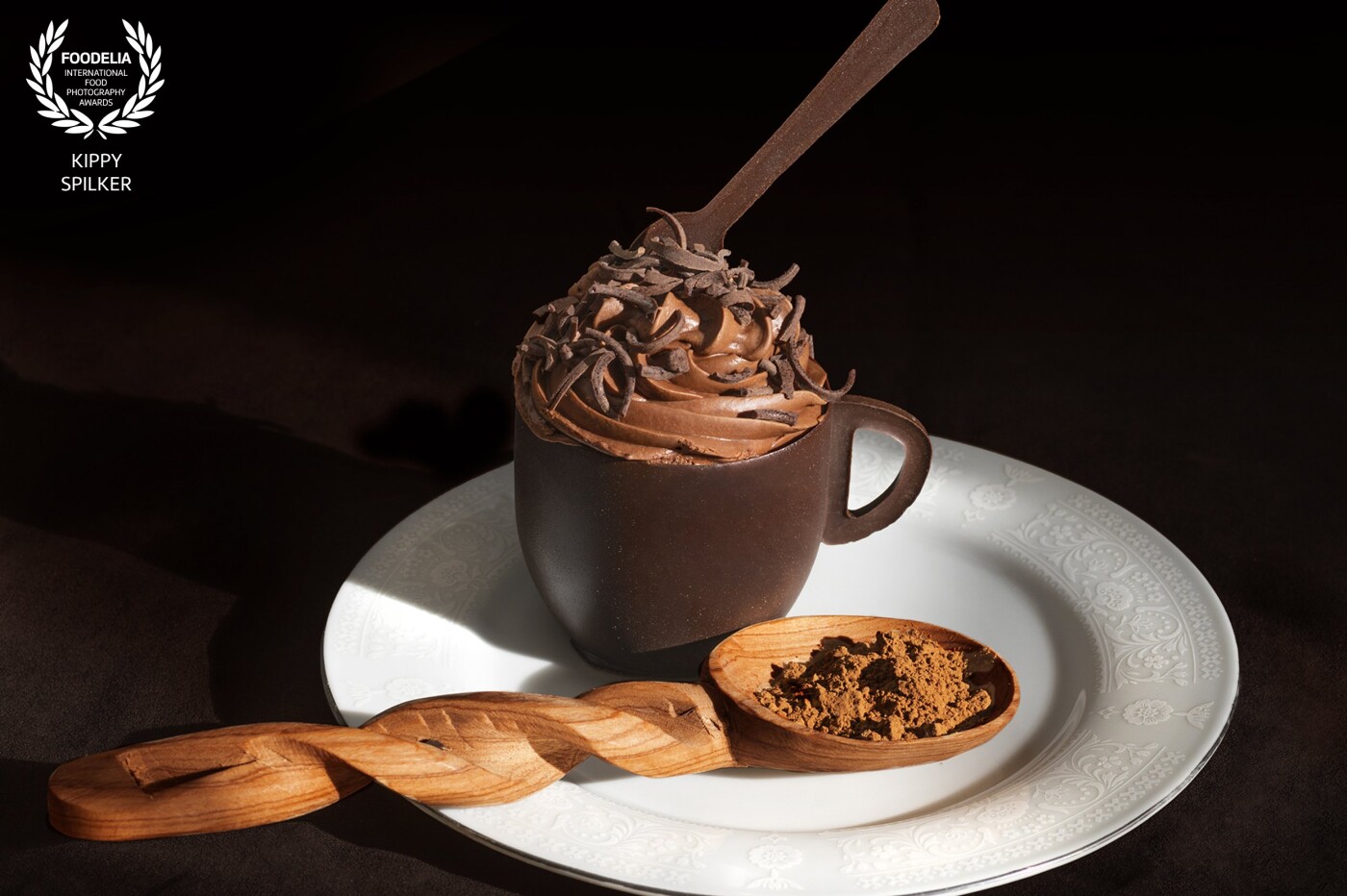 Dramatic natural lighting for chocolate overload. Chocolate teacup filled with chocolate mousse, topped by a chocolate spoon and chocolate shavings, created by the artisans at L.A. Bakery in Carson City, NV.