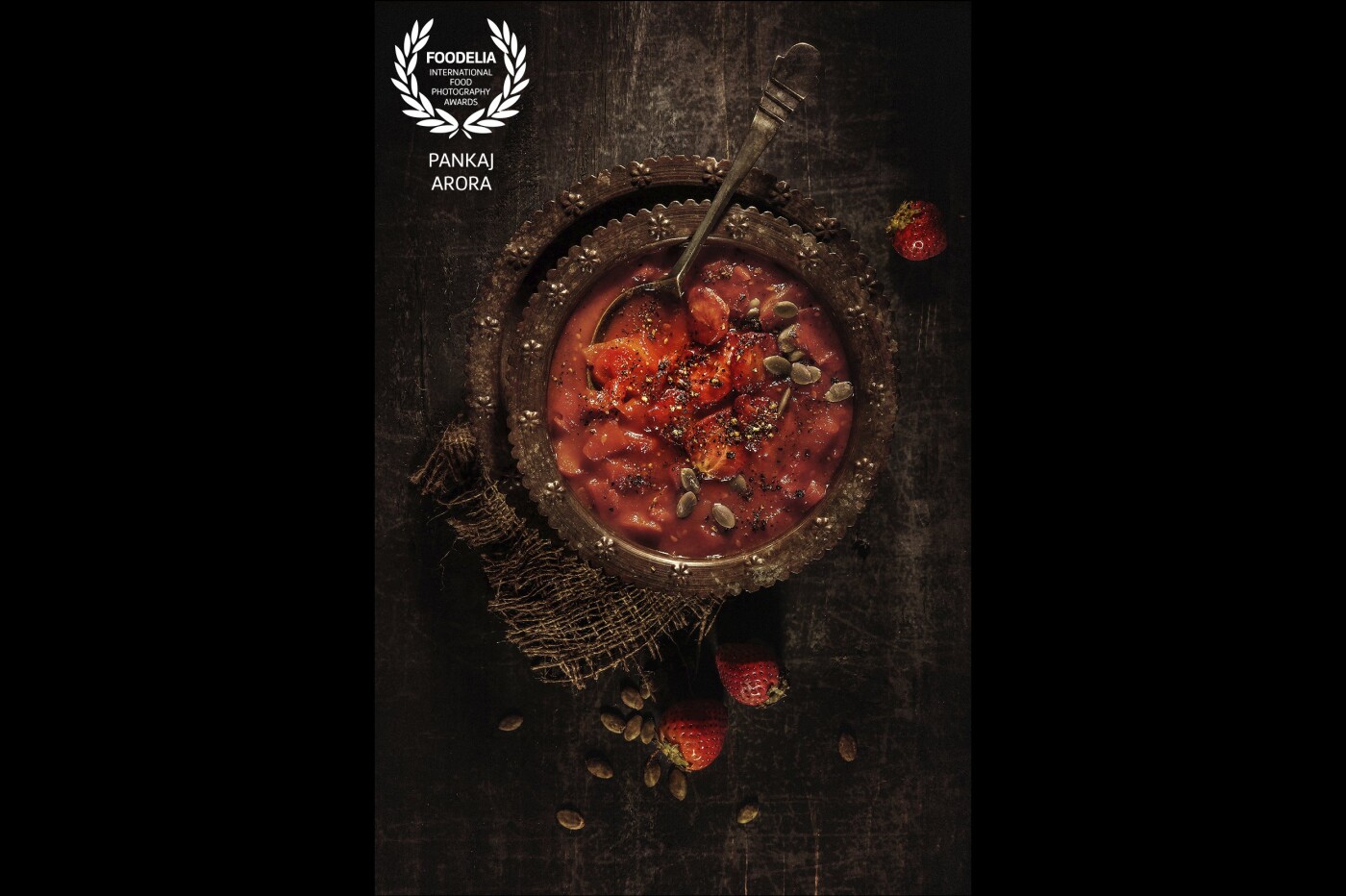 Slowly roasted strawberry and pumpkin cold soup served in a traditional Indian beaten copper serving dish. <br />
Photography style Dark and Moody. <br />
Food Styling by Anjali Ramaswamy