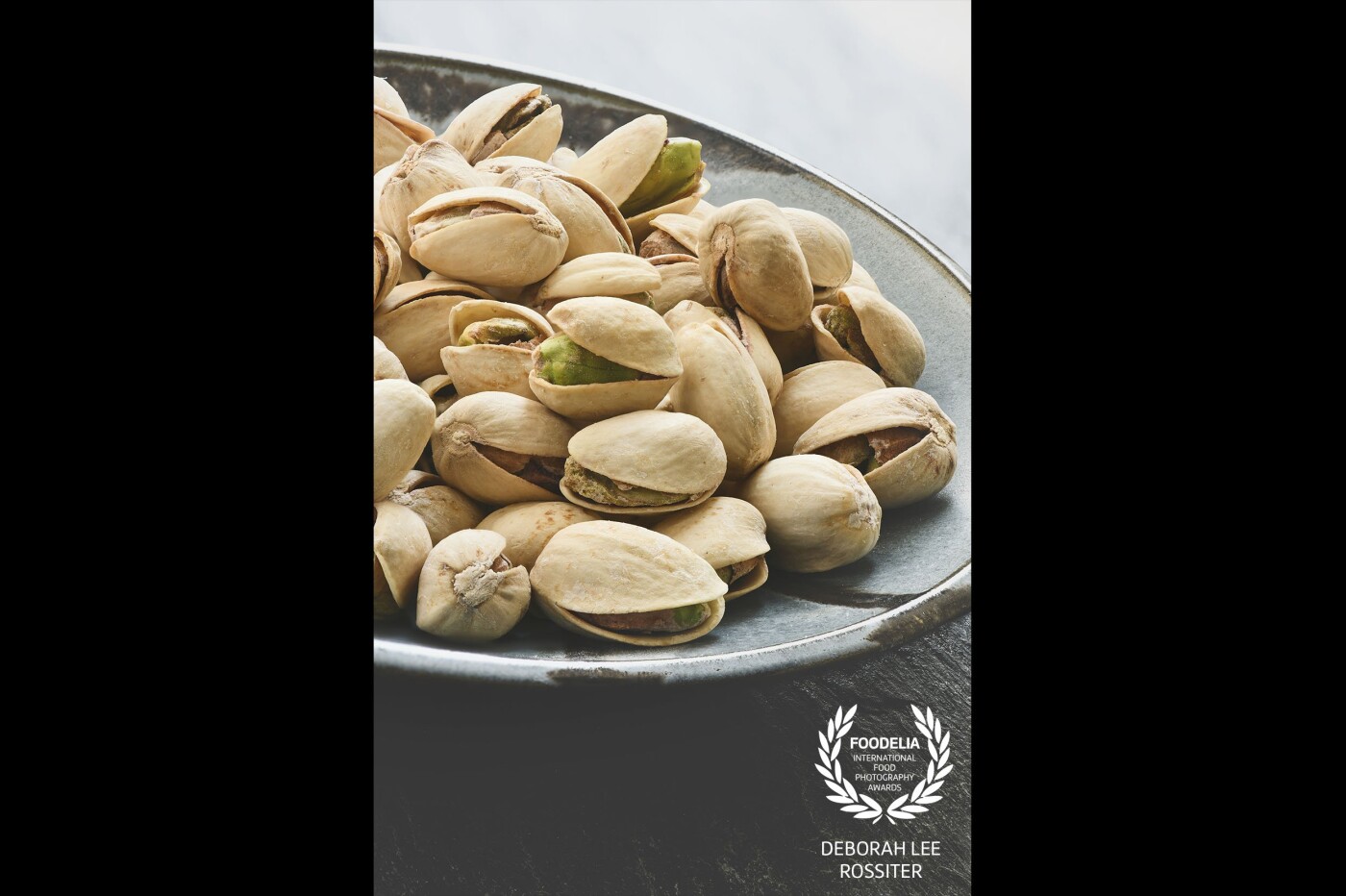 I wanted this image to be light and very soft so the green nuts stood out from the plain shell. These Pistachios where shot in window light 