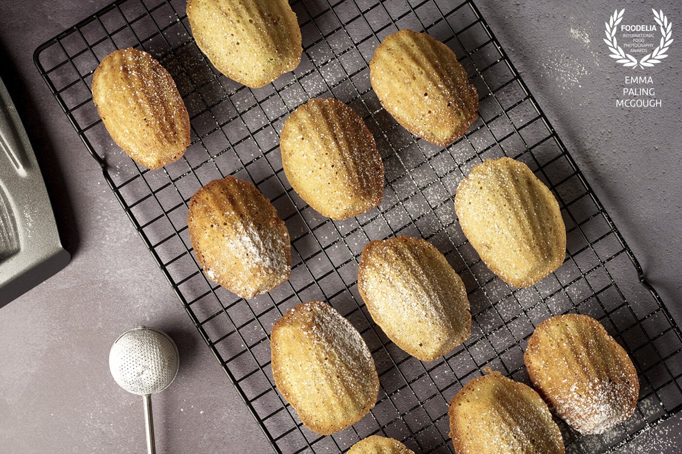 This was a personal project using my own kitchen as a studio and minimal kit, just a backdrop and some black boards. I wanted to create a nice soft light so used a big modifier and a reflector. Madeleines with pistachio nut and orange blossom, served with a light dusting of icing sugar.