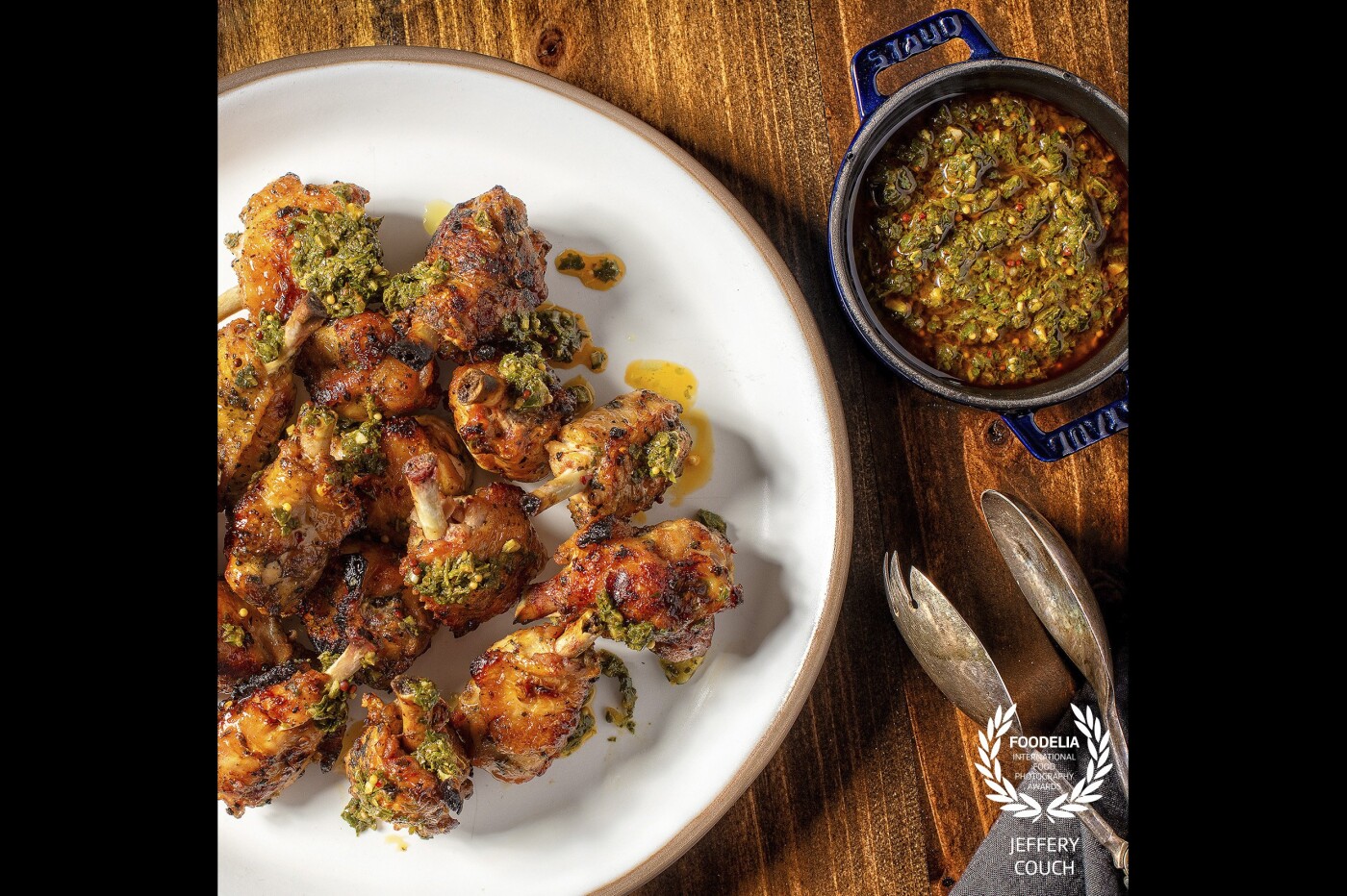 Photoshoot for Charcoal Venice catering menu, Smoky Grilled Chicken Wings, Oregano, Chili, and Vinegar, shown with smoked paprika mustard chimichurri. <br />
@charcoalvenice<br />
@josiahcitrin
