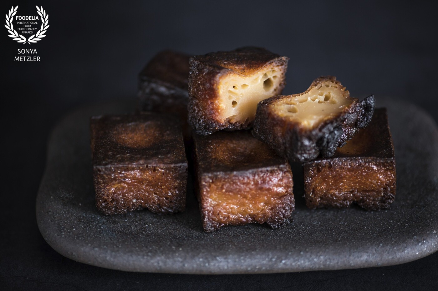 French Japanese fusion dessert in square design - le canelé en Japonais. Thanks, @omotesando.koffee . Shot in daylight on a slate by @madeinjapanuk 