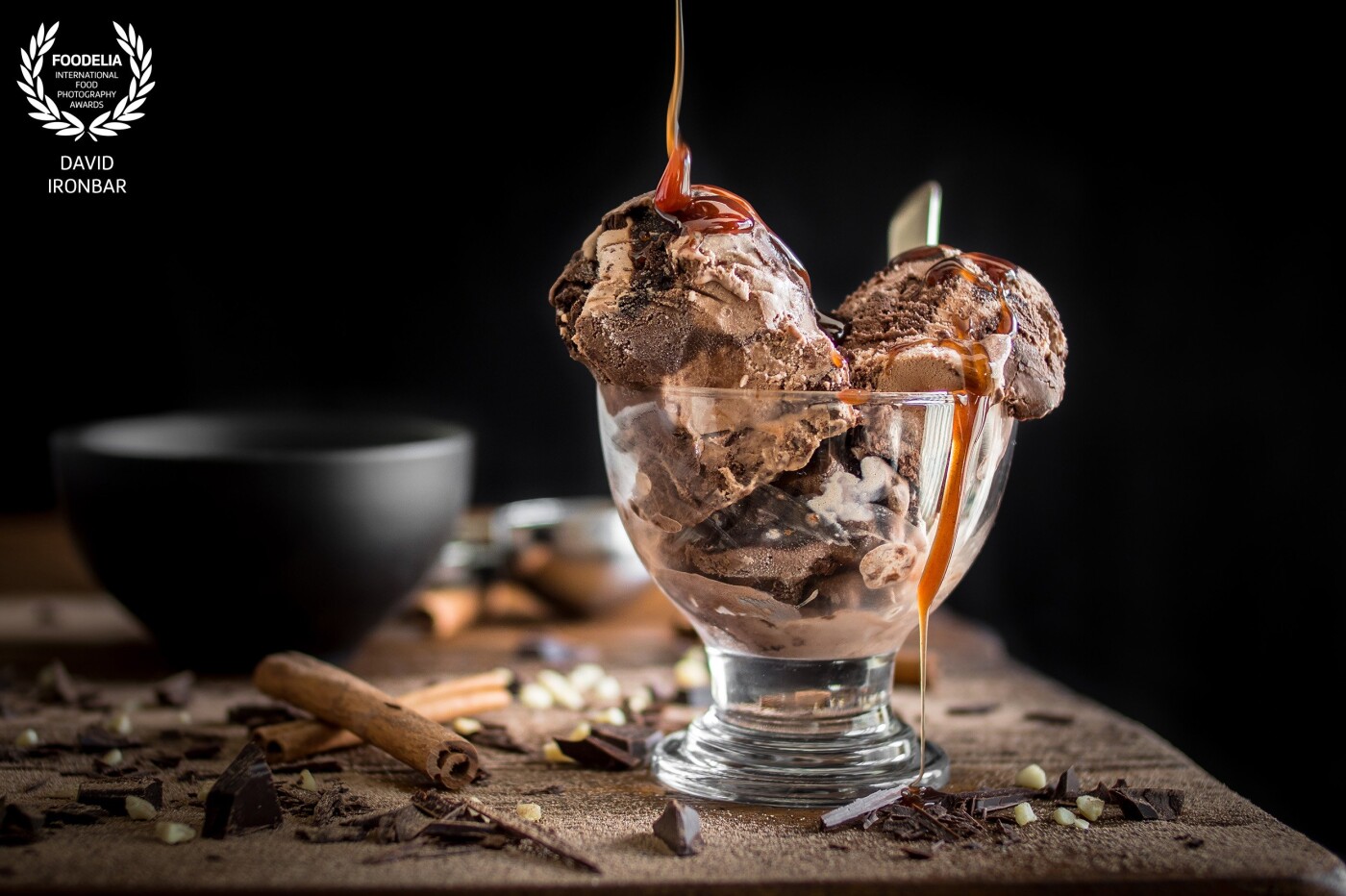 This no-churn triple chocolate ice cream is so rich and dense, with a sprinkle of chopped nuts and chocolate sauce. Taken in natural light.