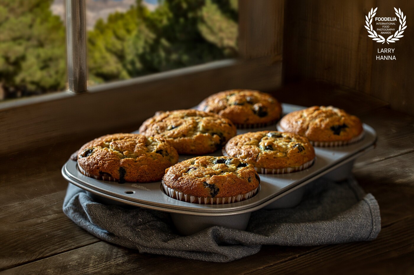 I made these banana/blueberry muffins for my family's consumption and decided to create a photograph of them.  The image was created in my kitchen using natural light on a set I made.<br />
