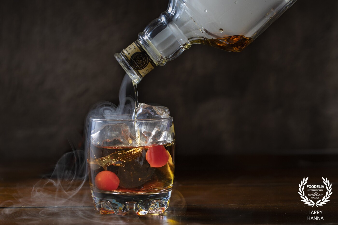 I recently saw someone in a bar being served a smoked Manhattan and was mesmerized by the presentation.  I did a little research and made my own in the studio using a strobe light to freeze the flowing smoke.  Tasted pretty good, also.