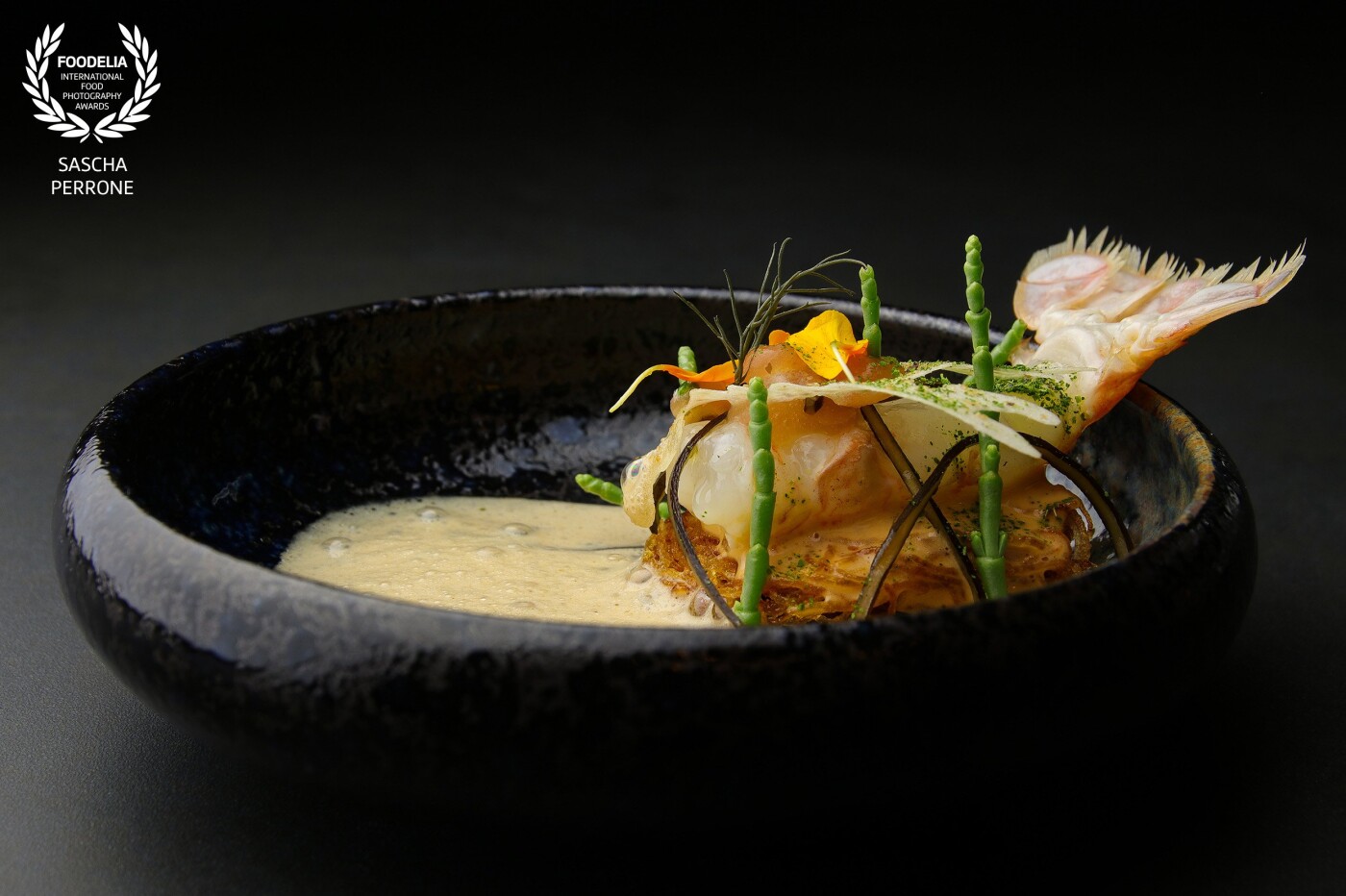 A dish with langostino by Chef Pierre Beckerling in the restaurant IUMA by Dyllong & De Luca in Dortmund - Germany. IUMA is a restaurant with an international atmosphere and cuisine inspired by Japan, which also remains true to the products from the local region.