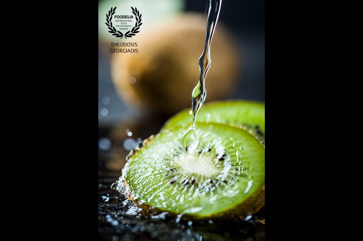  Splash photography!<br />
This shot was taken using  special high speed strobes.<br />
Close up of kiwi with water falling over, capturing the drops.<br />
